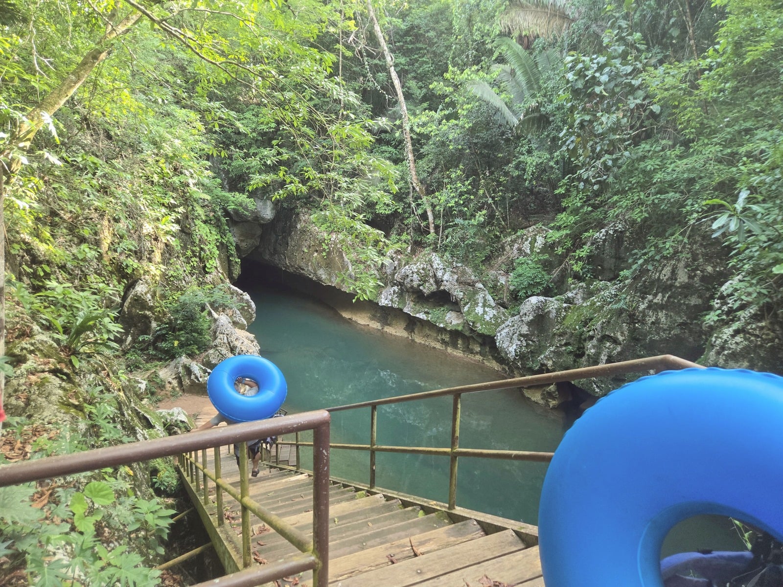 Team members cave tubing through a jungle river