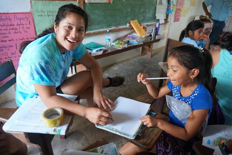 A team member tutoring a student in the classroom