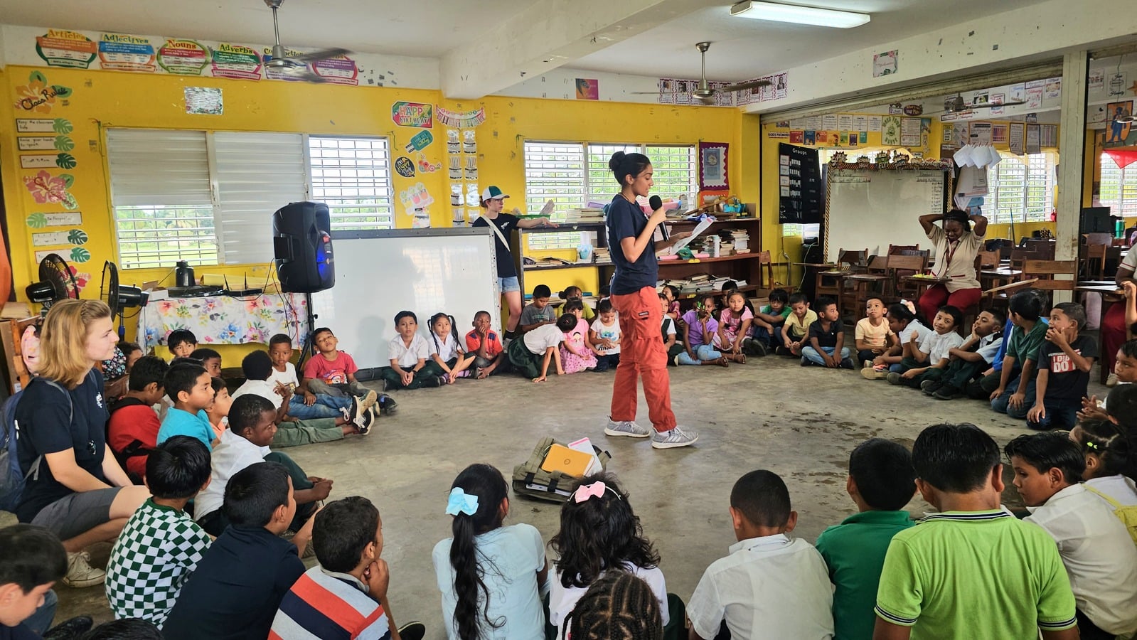 A team member leading a lesson with students seated in a classroom circle