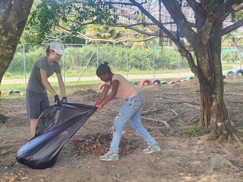 Team members clearing debris during a community cleanup project