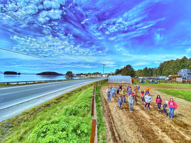 A team working in a field along the coast of Kodiak Island, Alaska