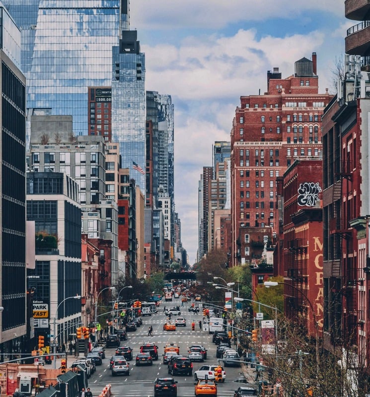 A busy Manhattan street lined with buildings