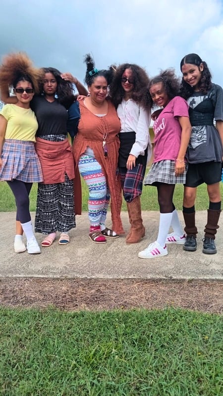 Students posing together outdoors on campus