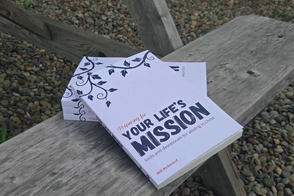 Copies of the Preparing for Your Life&rsquo;s Mission book stacked on a wooden bench