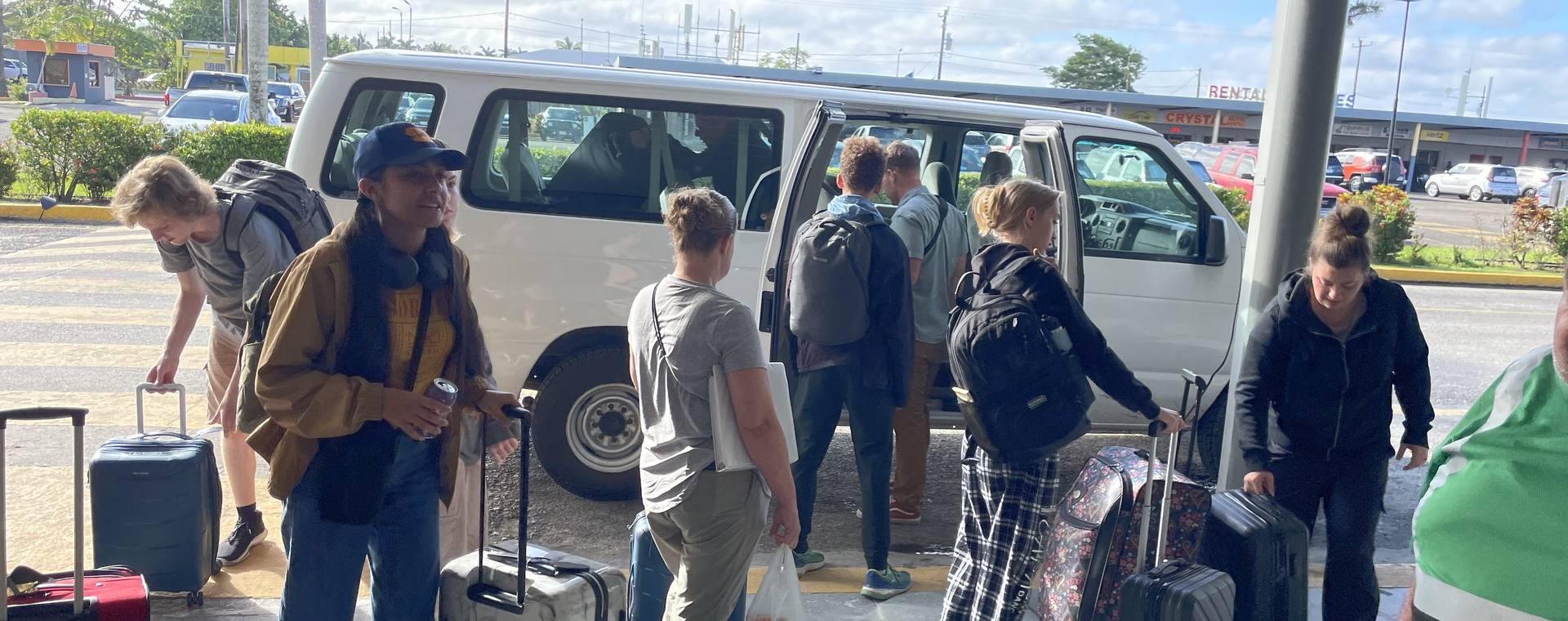 A GO Serve team loading luggage into a van at the start of a trip