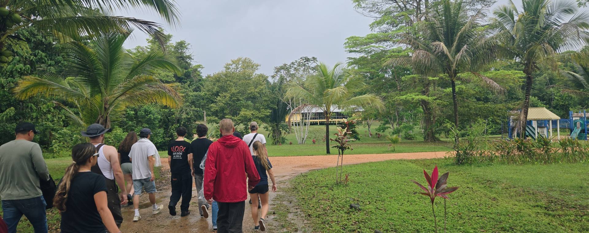 A GO Serve team walking together through a green partner site