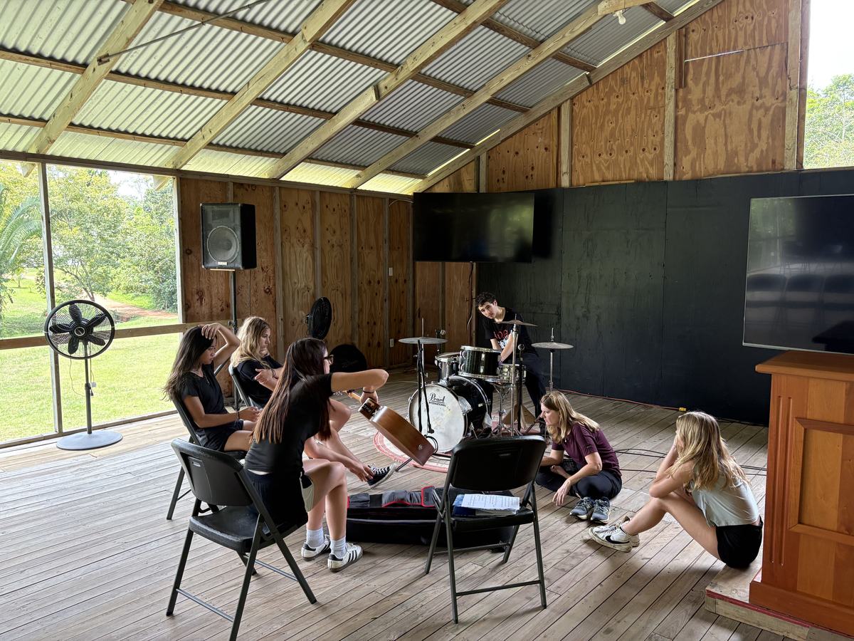 A team gathered in a circle for a worship time