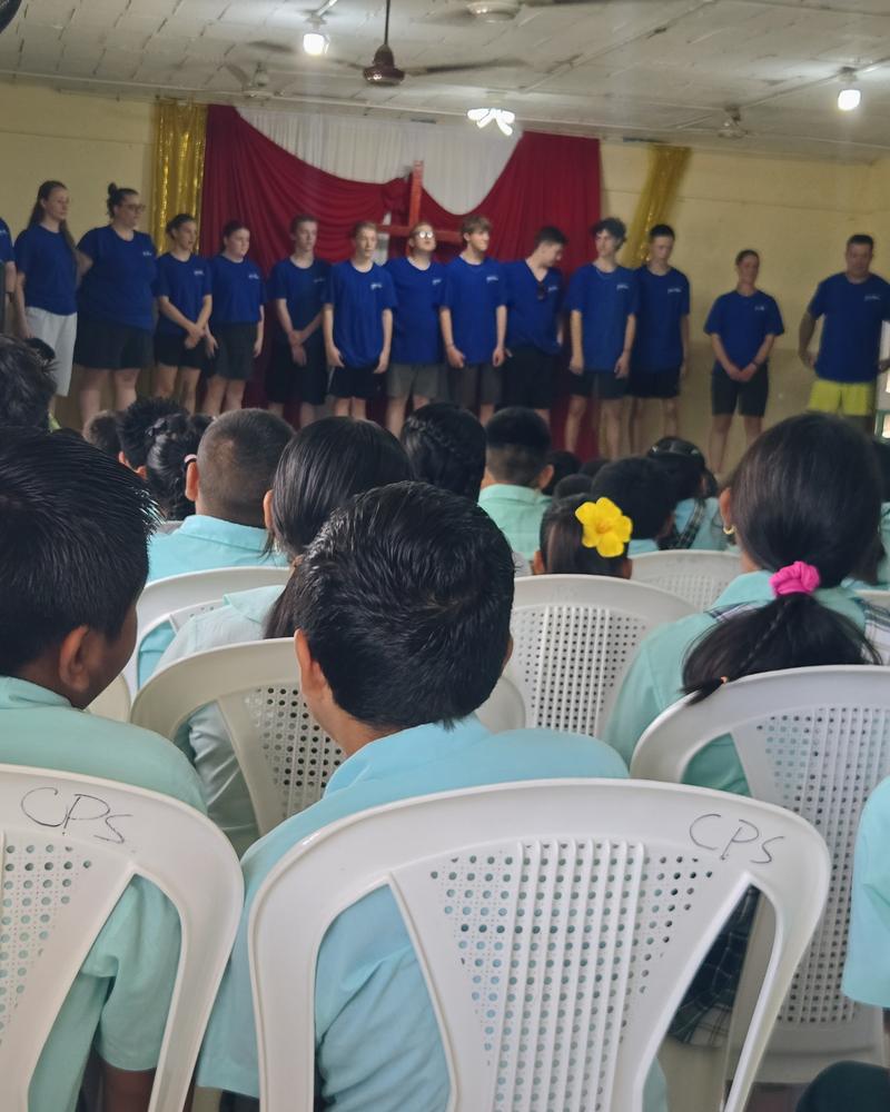 Christian school students gathered for an assembly with a GO Serve team