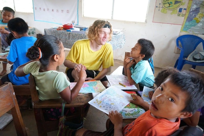 A team member doing crafts with students in the classroom